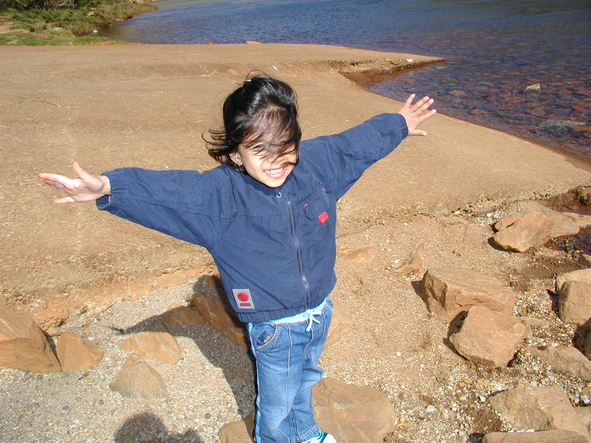 arms out smiling as a kid